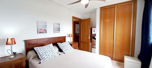 A bed or beds in a room at Gran Playa View Apartment