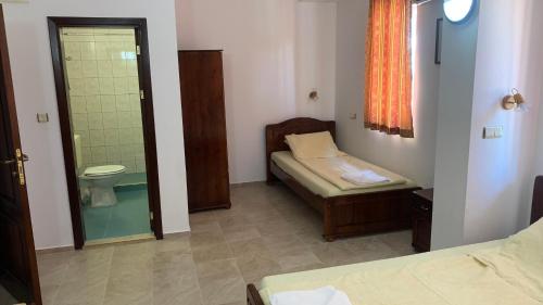 a room with a bathroom with a toilet and a shower at Guest House Katya in Nesebar