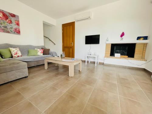 a living room with a couch and a coffee table at Aricobé in Ancient Epidavros