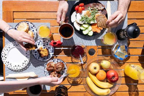 a group of people eating food on a table at Afroditi Apartments in Makry Gialos