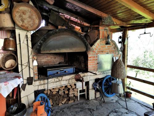 a brick oven with a bunch of pots and pans at Apatments Radoja - Pliva in Šipovo