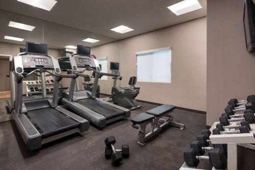 a gym with treadmills and machines in a room at Sonesta ES Suites Huntington Beach Fountain Valley in Huntington Beach
