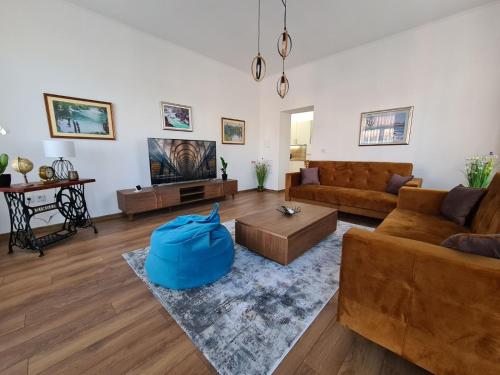 a living room with two couches and a tv at Penthouse City Center in Bihać
