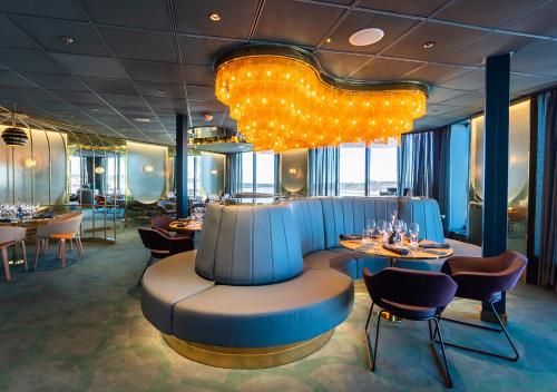 a restaurant with tables and chairs and a chandelier at Viking Line ferry Viking Glory - Mini-cruise from Stockholm in Stockholm