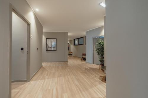 an empty room with a hallway with wood floors at River Eyes Suites in Vila Nova de Gaia