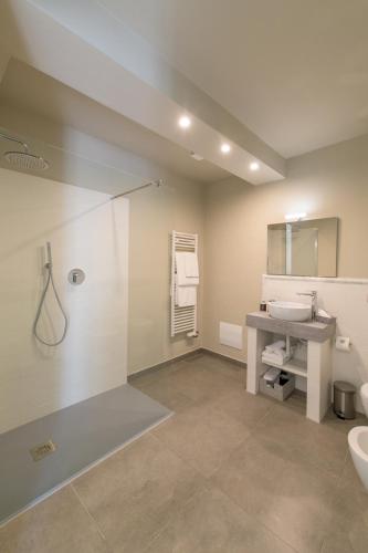 a bathroom with a shower and a sink at Palazzo Sertorio Suites in Gavi