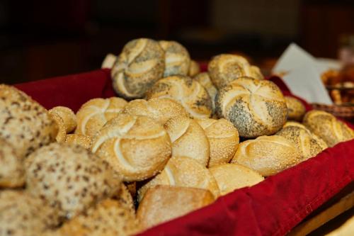 a pile of bagels in a red tray at Ruperti - Gästehaus in Ainring