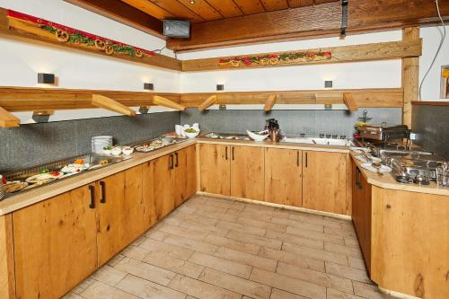 a large kitchen with wooden cabinets and counters at Ruperti - Gästehaus in Ainring