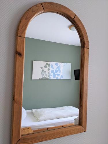 a mirror with a bed in a room at Hotel-Restaurant Im Goldenen Grund in Körperich