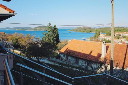 a house with an orange roof and a lake at Apartment VistaMare Croatia in Luka