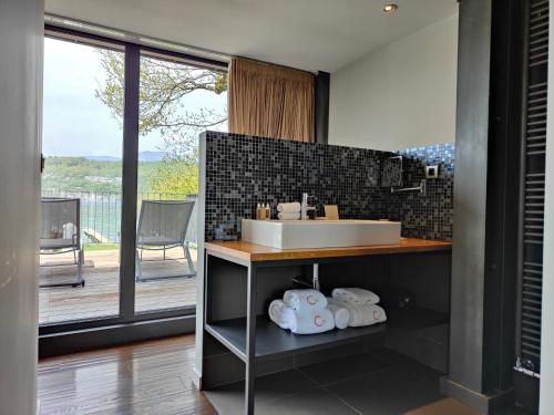 a bathroom with a sink and a counter at Le Clos Marcel in Duingt