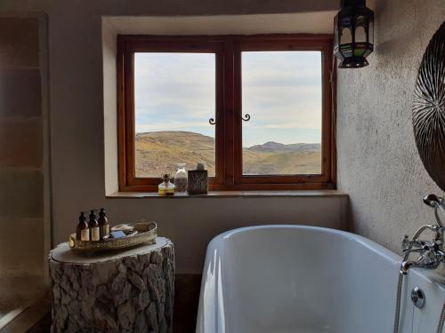 a bathroom with a bath tub and a window at Tenahead Lodge & Spa in Rhodes