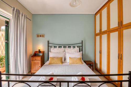 a bedroom with a large bed and a window at Dimeli Junior Apartment at the beach in Barbati