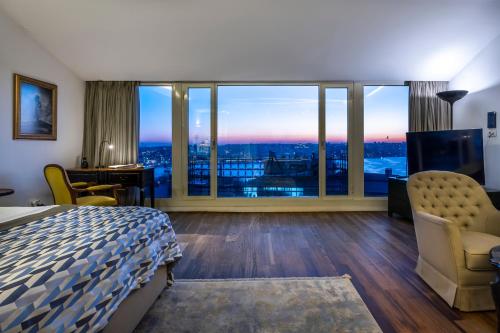 a hotel room with a bed and a large window at Ansen Hotel and Suites in Istanbul
