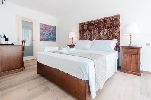 a bedroom with a large bed with a wooden floor at Palazzo Violetta in Sliema