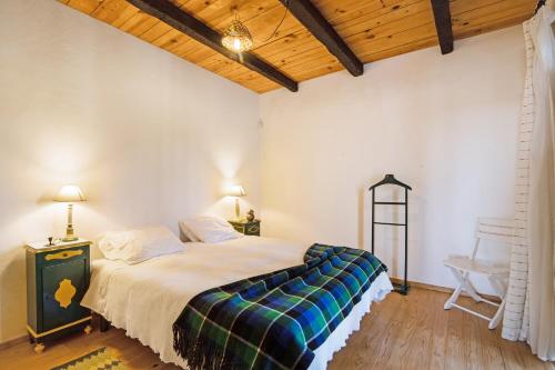 um quarto com uma cama e um tecto de madeira em Algarve Charming Rural 1br Villa em Santa Bárbara de Nexe