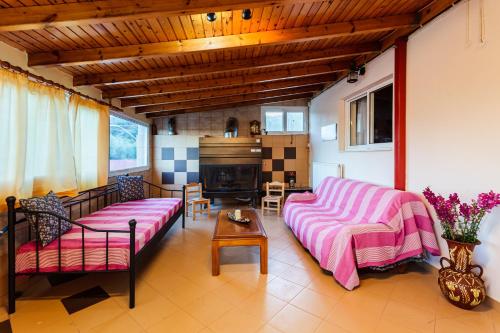 a living room with a couch and a table at Makarounis Athanasios Traditional Apartments(Ξενώνας) in Petalidhion