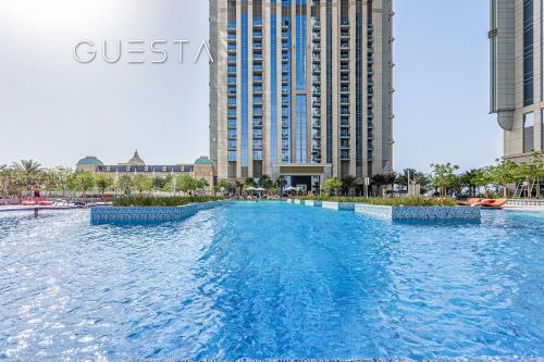 a large swimming pool in a city with tall buildings at Al Habtoor City, Business Bay in Dubai