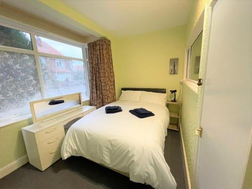 a small bedroom with a bed and a window at 1 Bedroom Ground Floor Holiday Apartment Skegness - Flat 11 in Skegness