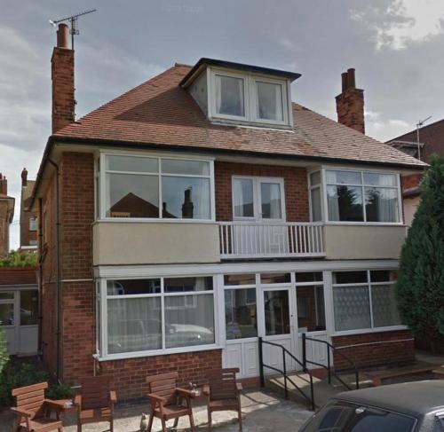 a brick house with windows and a balcony at 1 Bedroom Ground Floor Holiday Apartment Skegness - Flat 11 in Skegness