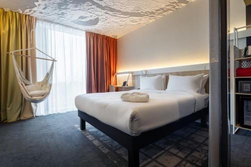 Ένα ή περισσότερα κρεβάτια σε δωμάτιο στο ibis Almaty Jetisu