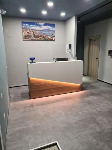 an office with a desk and a painting on the wall at Mia Suites Hotel Bella Capri in Naples