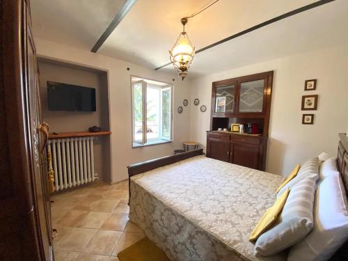 a bedroom with a bed and a flat screen tv at Casa Vacanze Cascina Mombello in Sinio