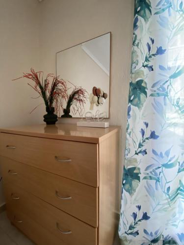 a dresser with a mirror on top of it at Seaside Apartment in Vergia Chalkidiki in Vergia