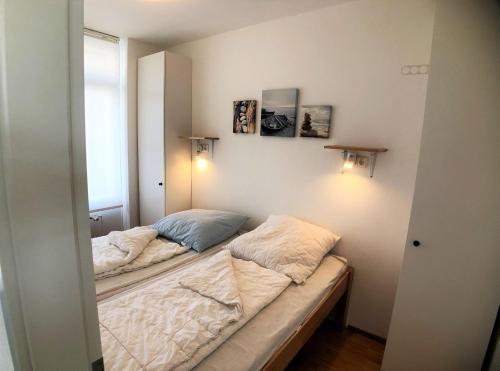 格羅森布羅德的住宿－Vier Jahreszeiten 6-10，一间小卧室,配有两张床和两盏灯