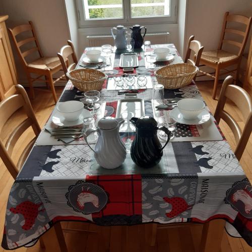 a dining room table with a table cloth on it at La maison in Tarnac