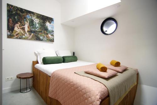 a bedroom with a bed with a painting on the wall at Magnificent houseboat with a stunning view! in Amsterdam