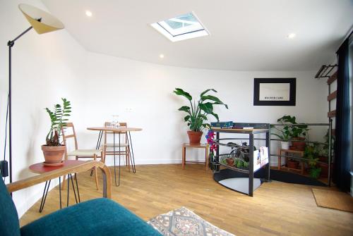 a living room with plants and a table and chairs at Magnificent houseboat with a stunning view! in Amsterdam
