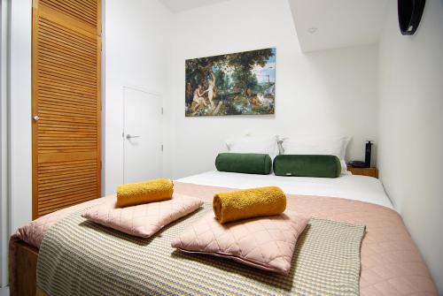 a bedroom with a bed with two pillows on it at Magnificent houseboat with a stunning view! in Amsterdam