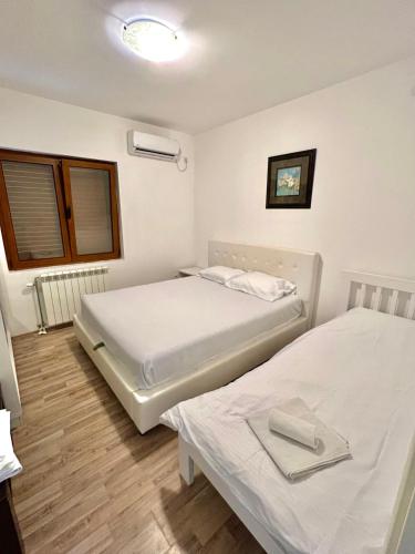 Postel nebo postele na pokoji v ubytování Apartments Family