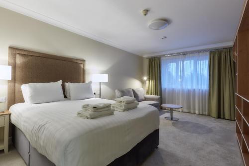 a hotel room with a large bed with towels on it at Southview Park Hotel in Skegness