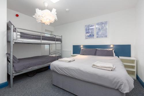 a bedroom with two bunk beds and a chandelier at Blackpool Lodge Apartments in Blackpool