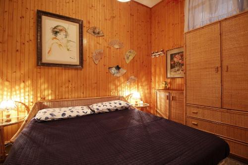 a bedroom with a bed in a room with wooden walls at MAL Portovenere Apartment in Portovenere