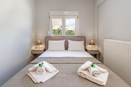 a bedroom with a bed with towels on it at Lagadi Apartment 8 in Lassi