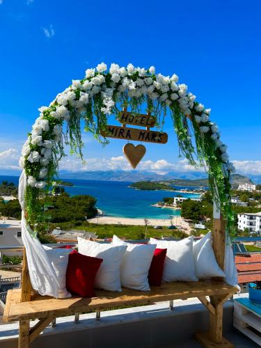 an arch with a couch on top of a balcony at Hotel Mira Mare in Ksamil