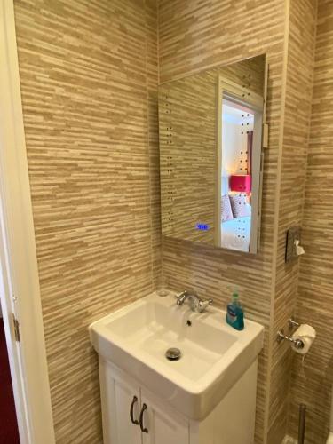 a bathroom with a sink and a mirror at Chester House Guest House in Chester