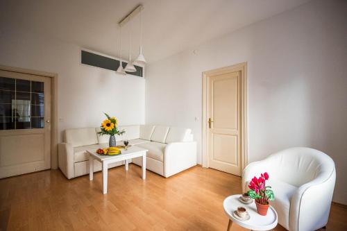 a living room with a white couch and a table at Bright and Modern 1BDR Apartment in the Center in Sarajevo