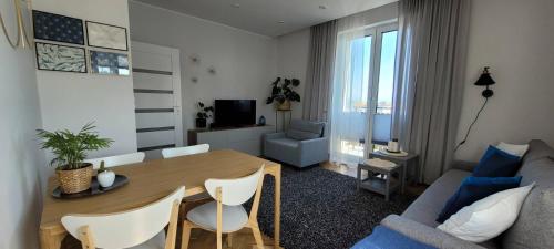 a living room with a table and a couch at Apartament Abrahama in Władysławowo