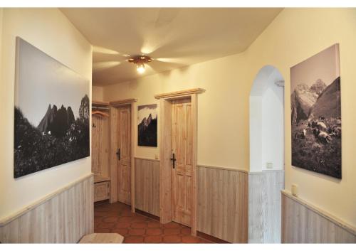a hallway with a door and paintings on the walls at Bergpanorama in Oberstdorf