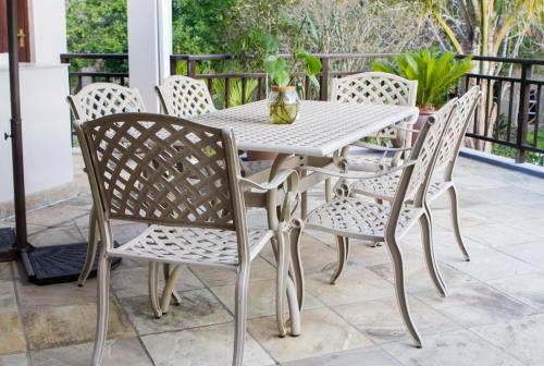 a white table and chairs on a patio at Cherry Berry Guest House in George