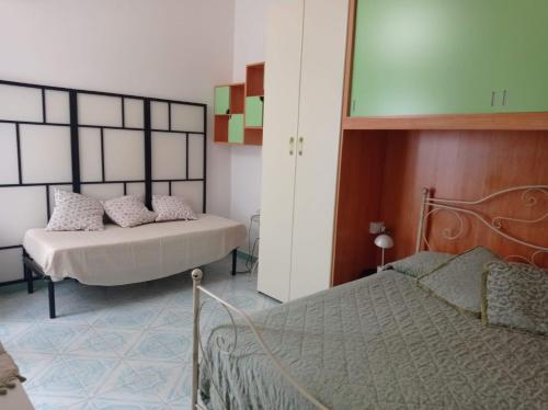 En eller flere senge i et værelse på Appartamento Iasolino