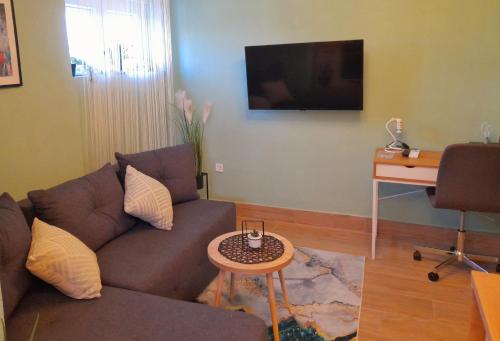 a living room with a couch and a table at Apartman Sunny Lika in Gospić