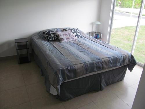 a large bed in a bedroom with a window at ADVENTURE House in Nancito