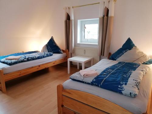 a bedroom with two beds and a window at Haus Sperbermühle in Hannover