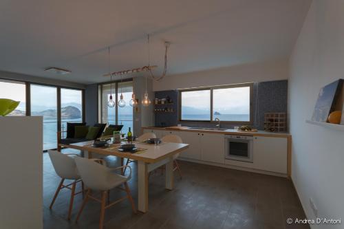 a kitchen and dining room with a table and chairs at Seafront Holiday House on the Mindelo Bay in Mindelo
