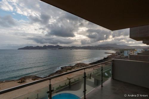 a view of the ocean from the balcony of a building at Seafront Holiday House on the Mindelo Bay in Mindelo
